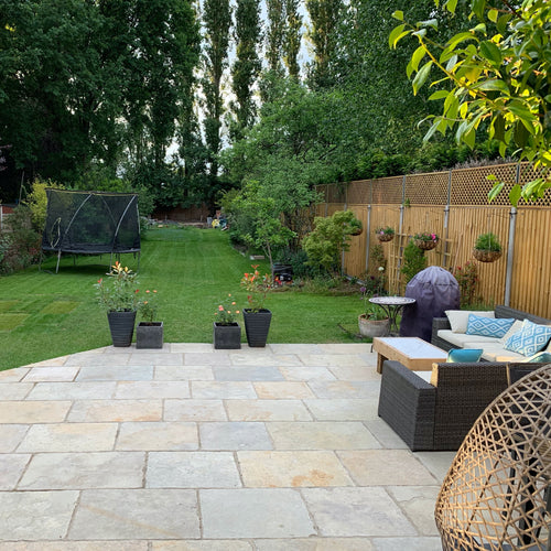 Minster Natural Finish Limestone external paving tiles in garden with rattan furniture
